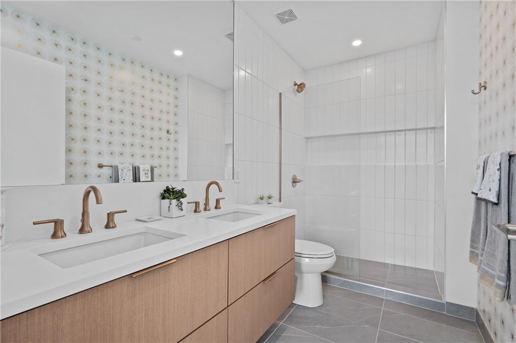 2554 Smallman Street, Unit 504 Pittsburgh, PA 15222 - Photo 13 of 29 a bathroom with a double vanity sink toilet and shower