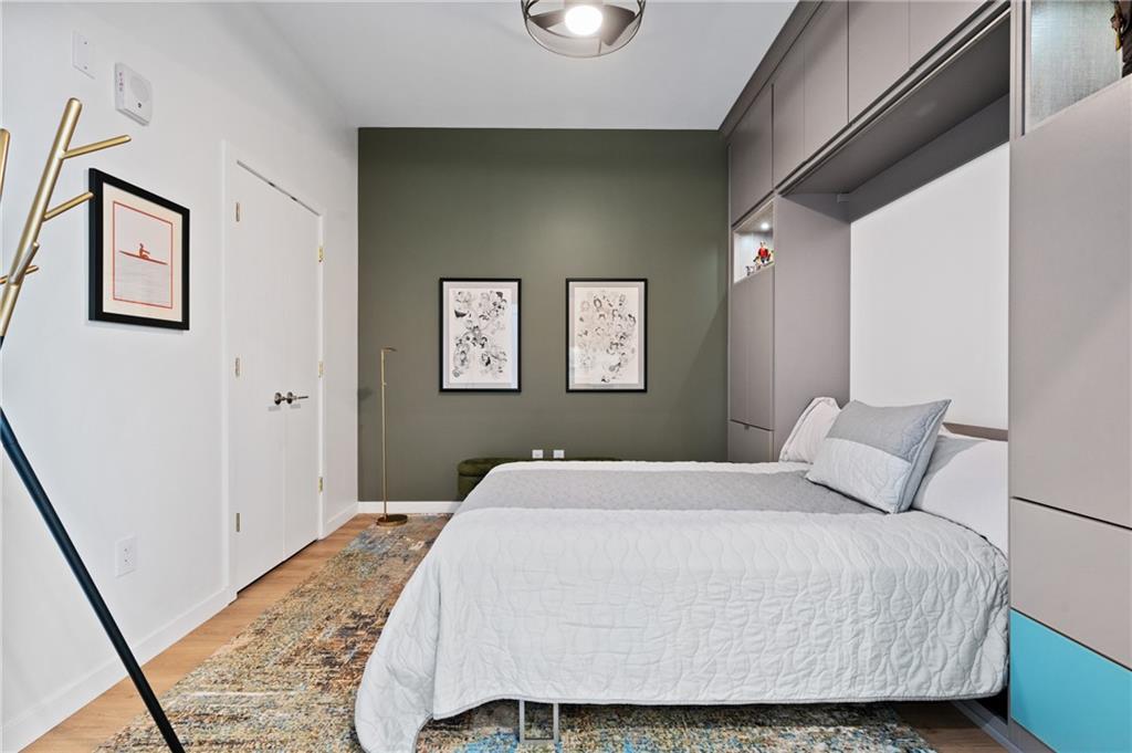 2554 Smallman Street, Unit 504 Pittsburgh, PA 15222 - Photo 17 of 29 a bedroom with a bed and painting on the wall
