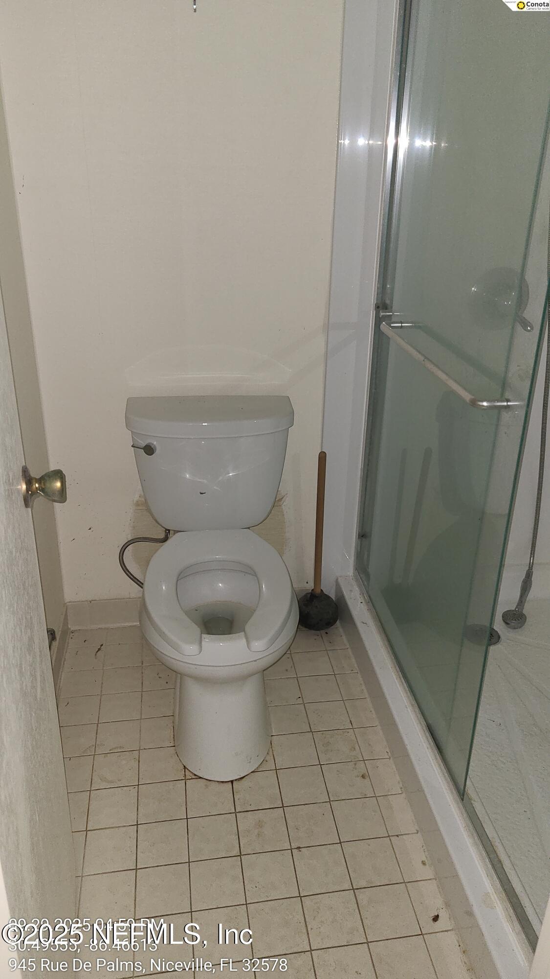 945 Rue De Palms Niceville, FL 32578 - Photo 12 of 37 a white toilet sitting next to a shower