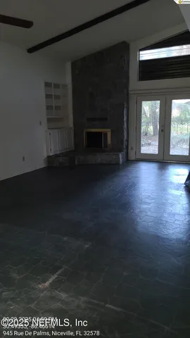 a view of empty room with window and fireplace