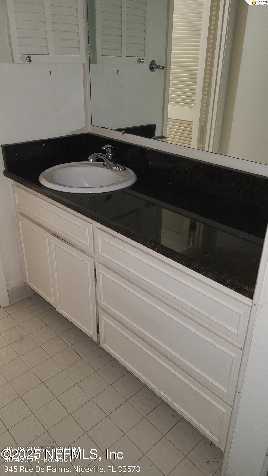 945 Rue De Palms Niceville, FL 32578 - Photo 21 of 37 a bathroom with a sink and a mirror