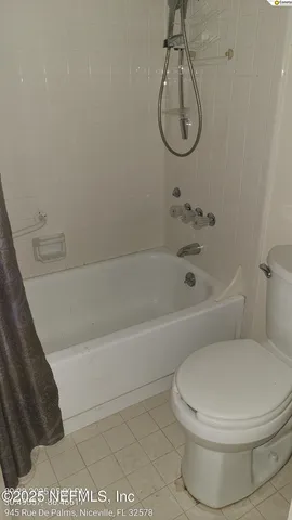 a bathroom with a bath tub with a shower
