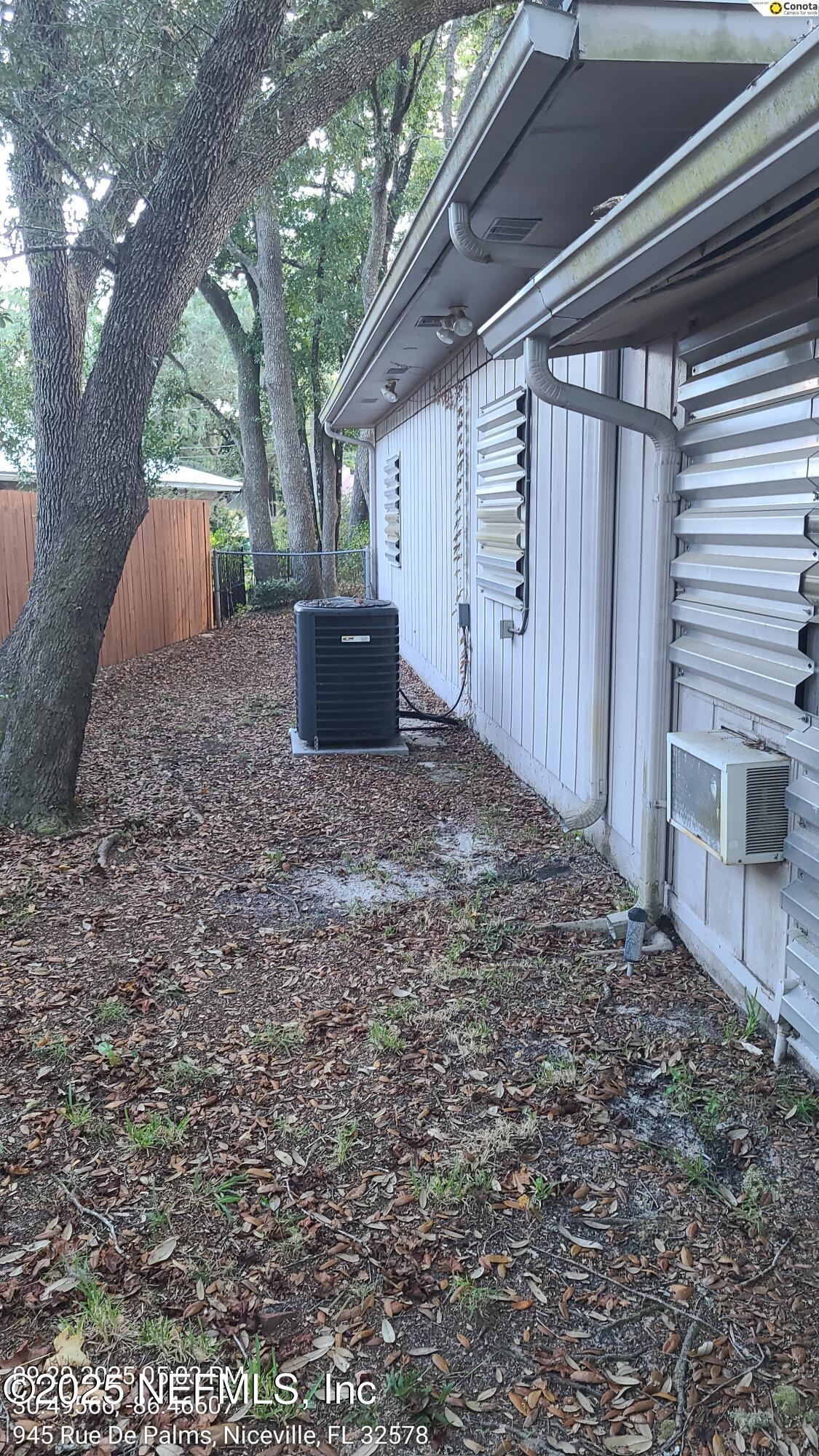 945 Rue De Palms Niceville, FL 32578 - Photo 37 of 37 a view of a backyard with large trees and wooden fence