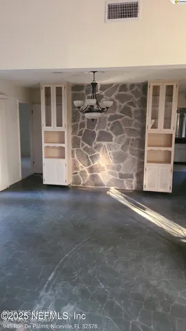 a view of an empty room with a cabinet