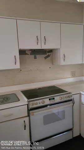 a stove top oven sitting inside of a kitchen