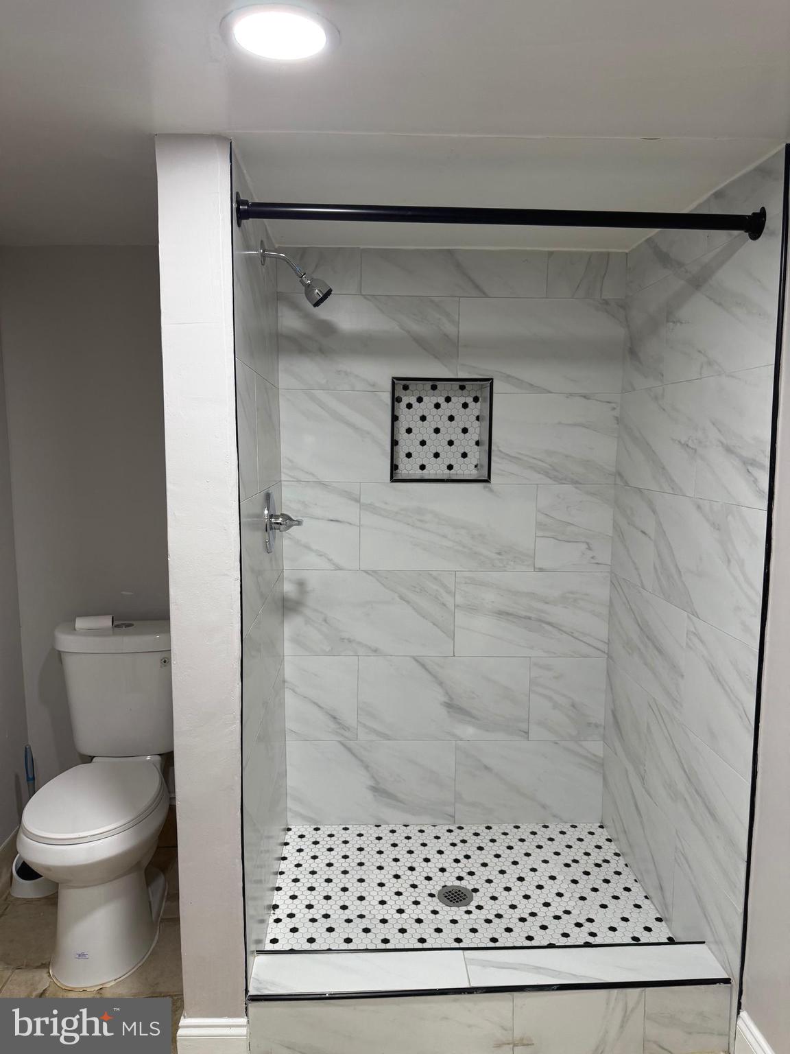 1353 Cambria Street Baltimore, MD 21225 - Photo 18 of 23 a bathroom with a toilet and a shower