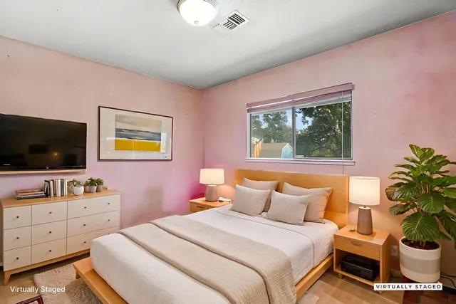 a bedroom with a bed and a flat screen tv