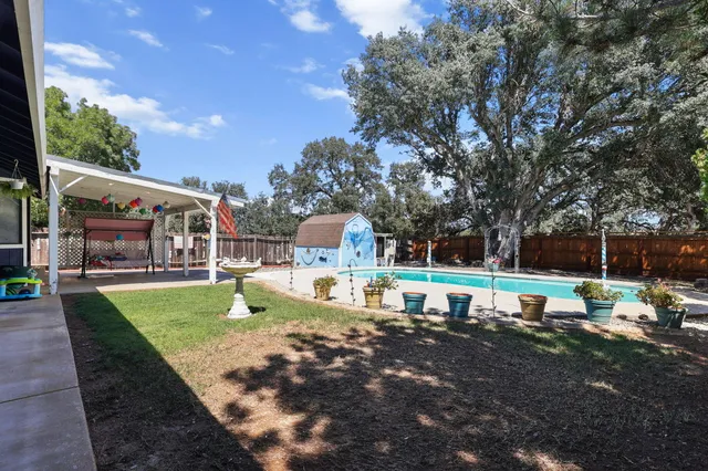 a view of a house with a yard patio and sitting area