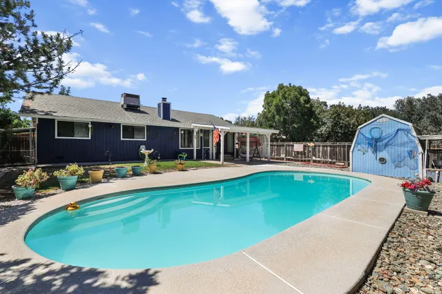 a view of a house with swimming pool and porch