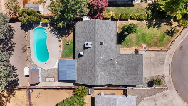an aerial view of a house with a swimming pool