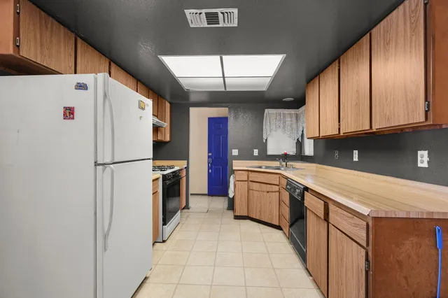 a kitchen with stainless steel appliances a refrigerator sink and cabinets