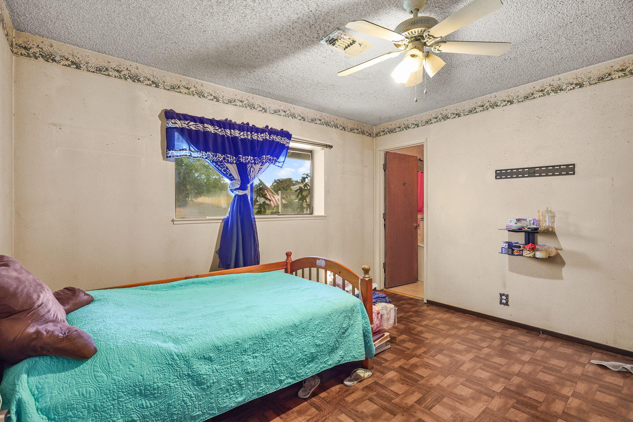 2760 Oriole Drive Red Bluff, CA 96080 - Photo 10 of 25 a bedroom with a bed and a chandelier