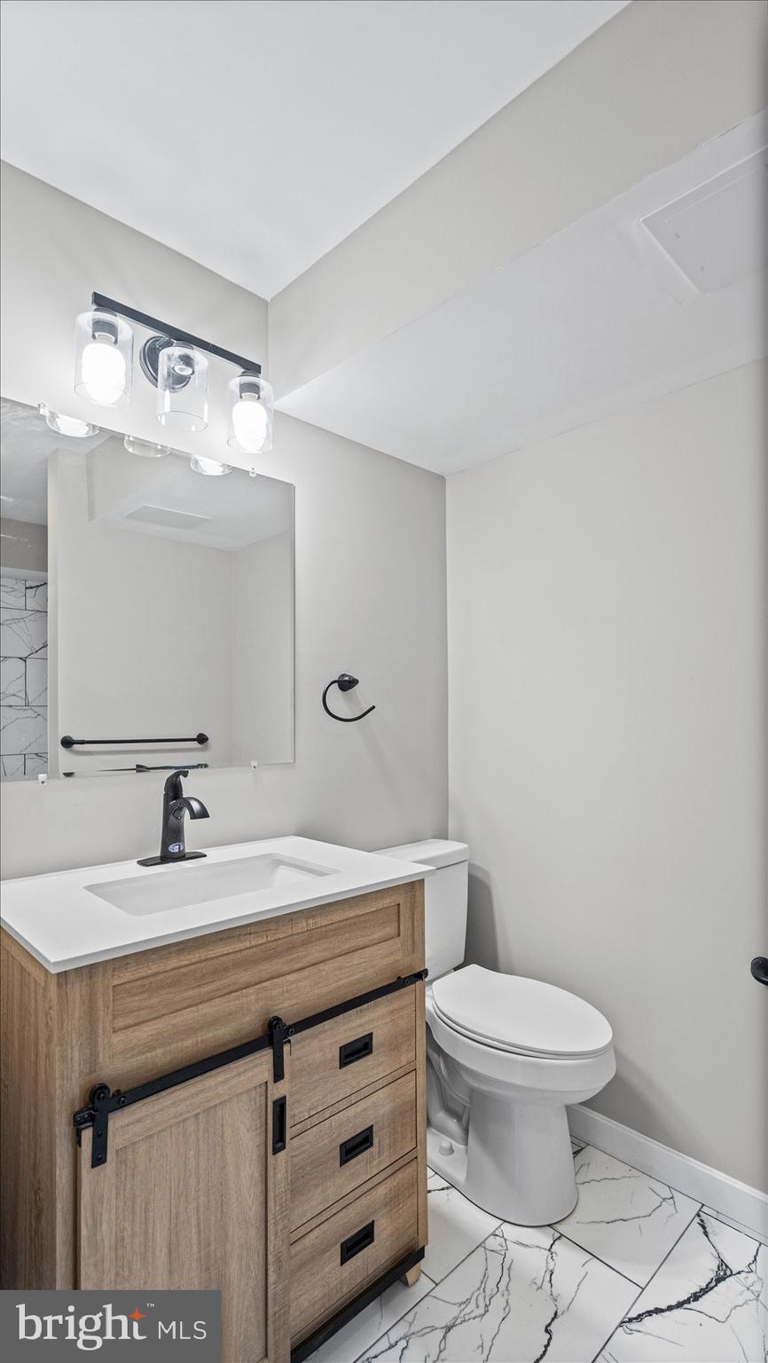 3709 Redberry Way Nottingham, MD 21236 - Photo 36 of 45 a bathroom with a sink a toilet and a mirror