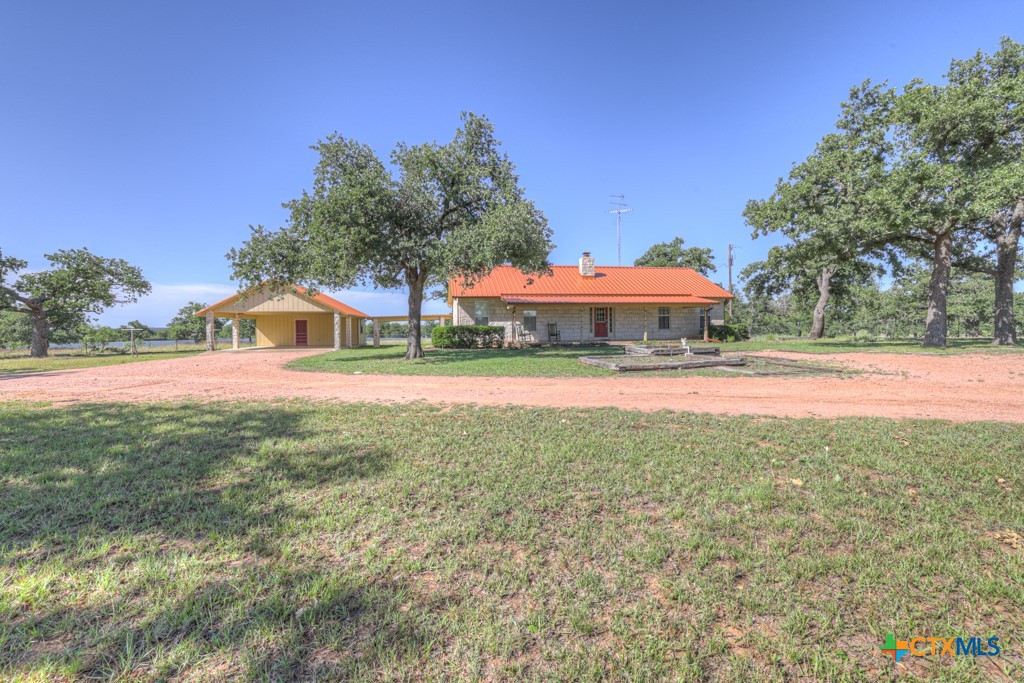 82 Bell Mountain Road Willow City, TX 78675 - Photo 3 of 41 a house view with a garden space
