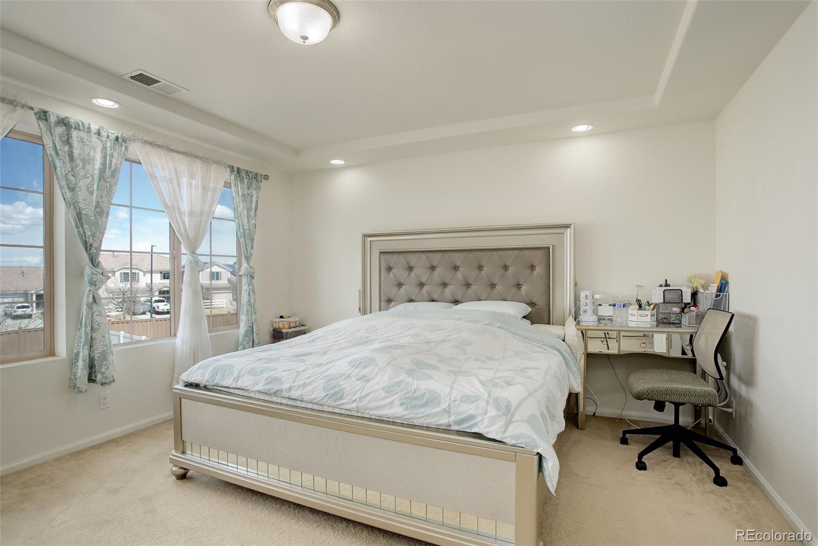 4971 Ceylon Way Denver, CO 80249 - Photo 15 of 40 a bedroom with a bed and a desk