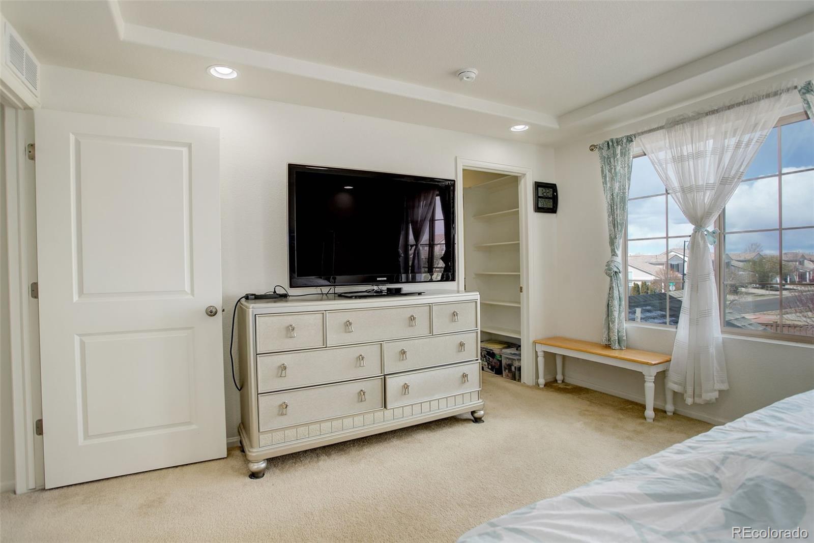 4971 Ceylon Way Denver, CO 80249 - Photo 17 of 40 a room with furniture and flat screen tv