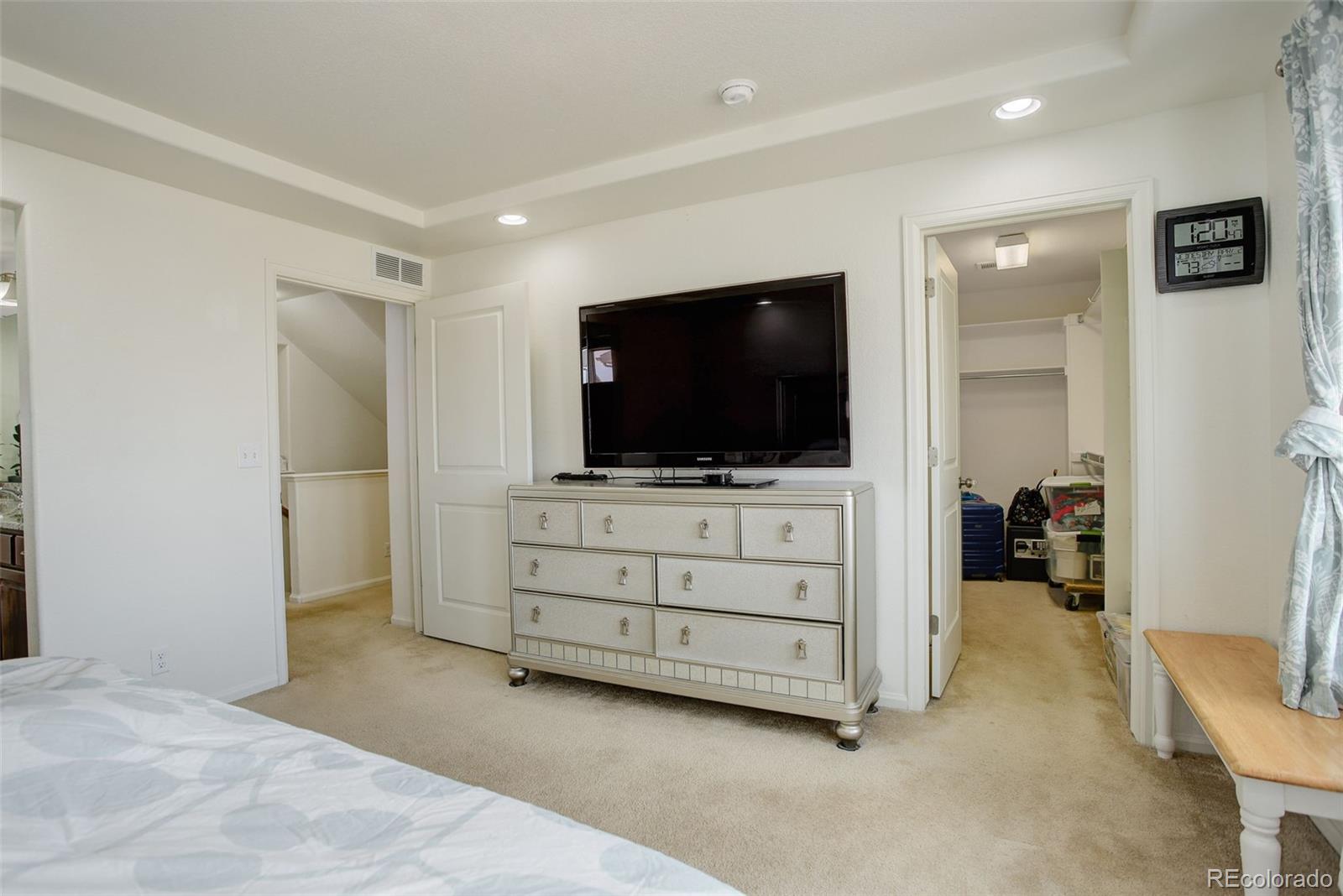 4971 Ceylon Way Denver, CO 80249 - Photo 18 of 40 a view of a livingroom with cabinet flat screen tv and a couch