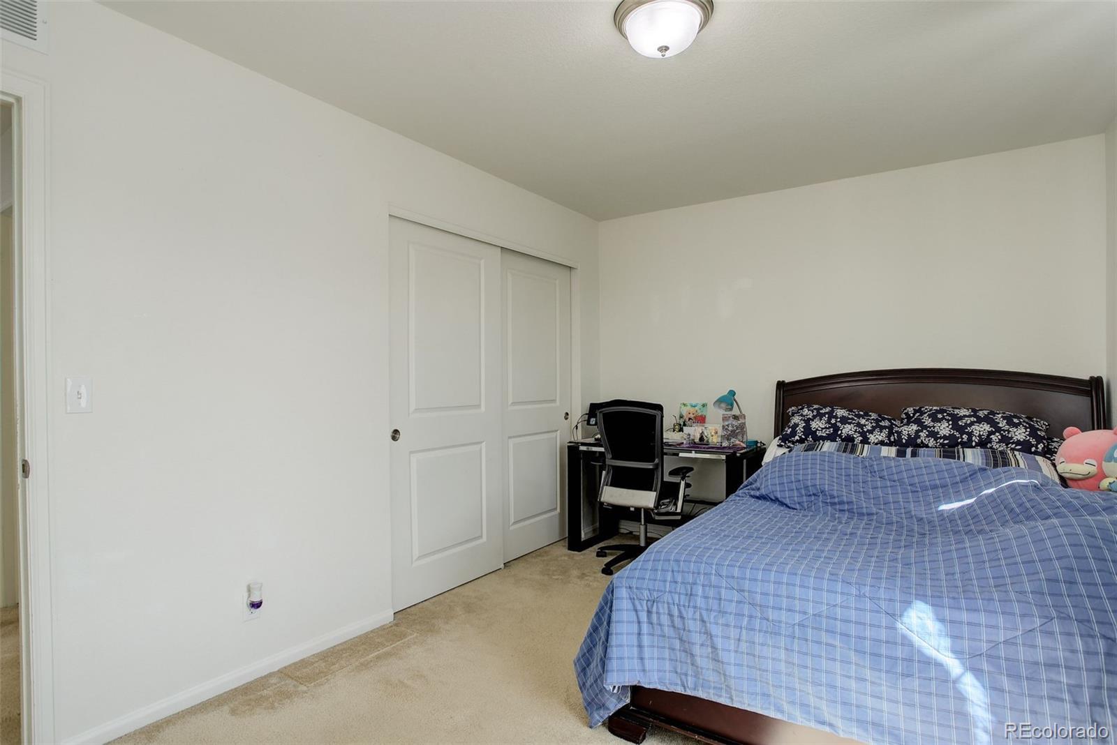 4971 Ceylon Way Denver, CO 80249 - Photo 20 of 40 a bedroom with a bed and a potted plant