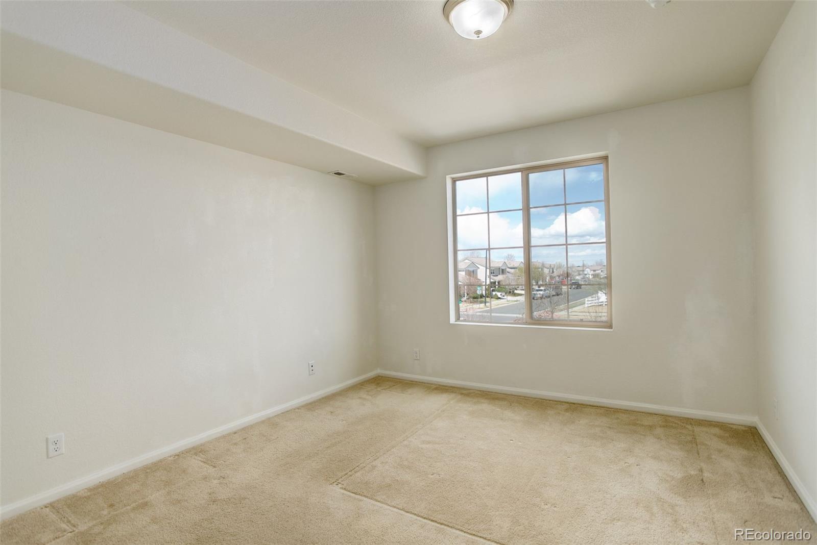 4971 Ceylon Way Denver, CO 80249 - Photo 23 of 40 an empty room with windows