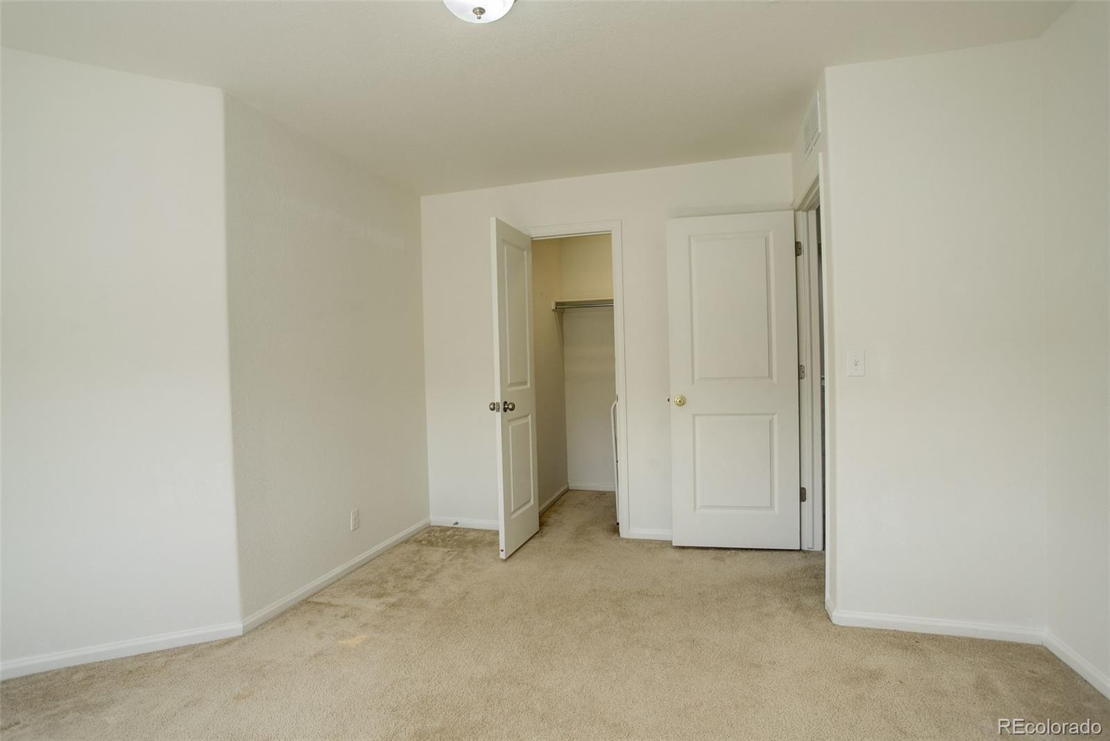 4971 Ceylon Way Denver, CO 80249 - Photo 27 of 40 a view of an empty room and closet area