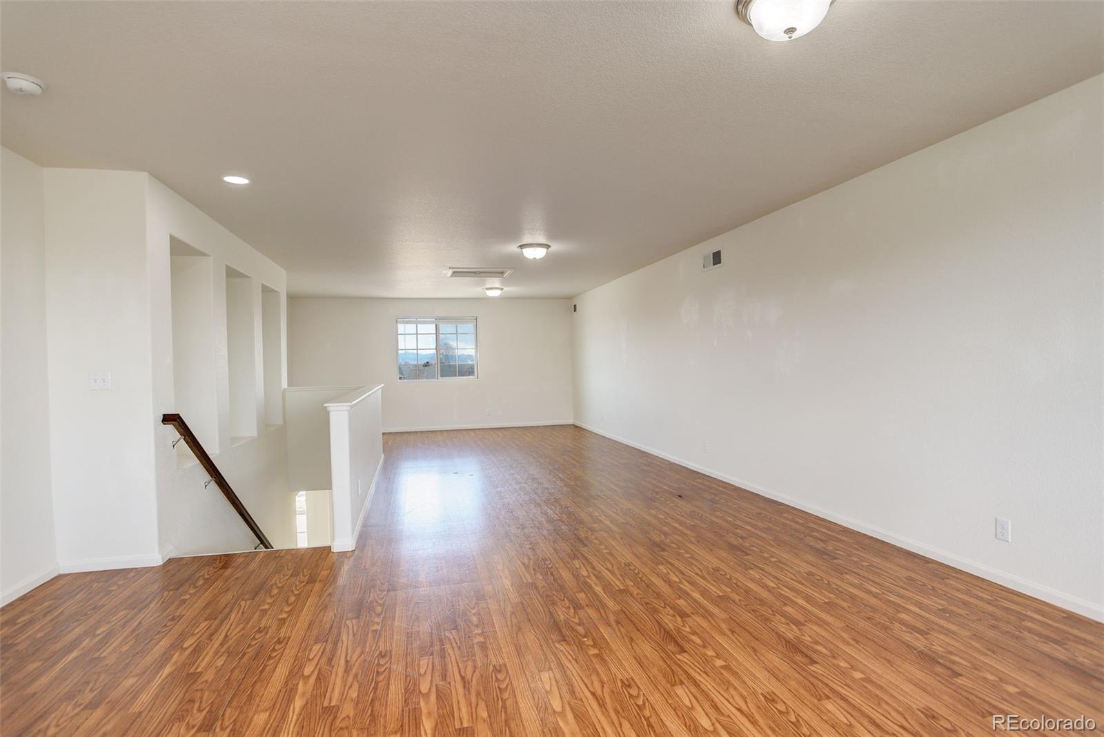 4971 Ceylon Way Denver, CO 80249 - Photo 29 of 40 a view of empty room with wooden floor