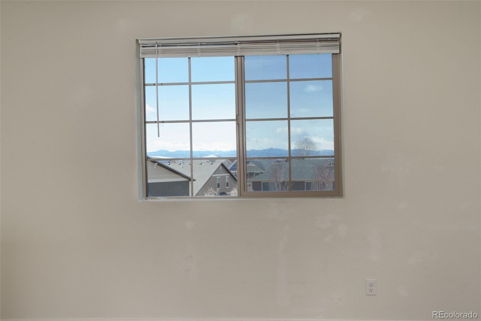 4971 Ceylon Way Denver, CO 80249 - Photo 31 of 40 a white building with a glass door