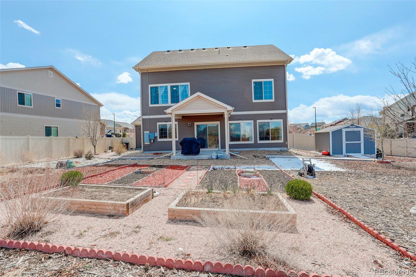 4971 Ceylon Way Denver, CO 80249 - Photo 34 of 40 a front view of a house with yard