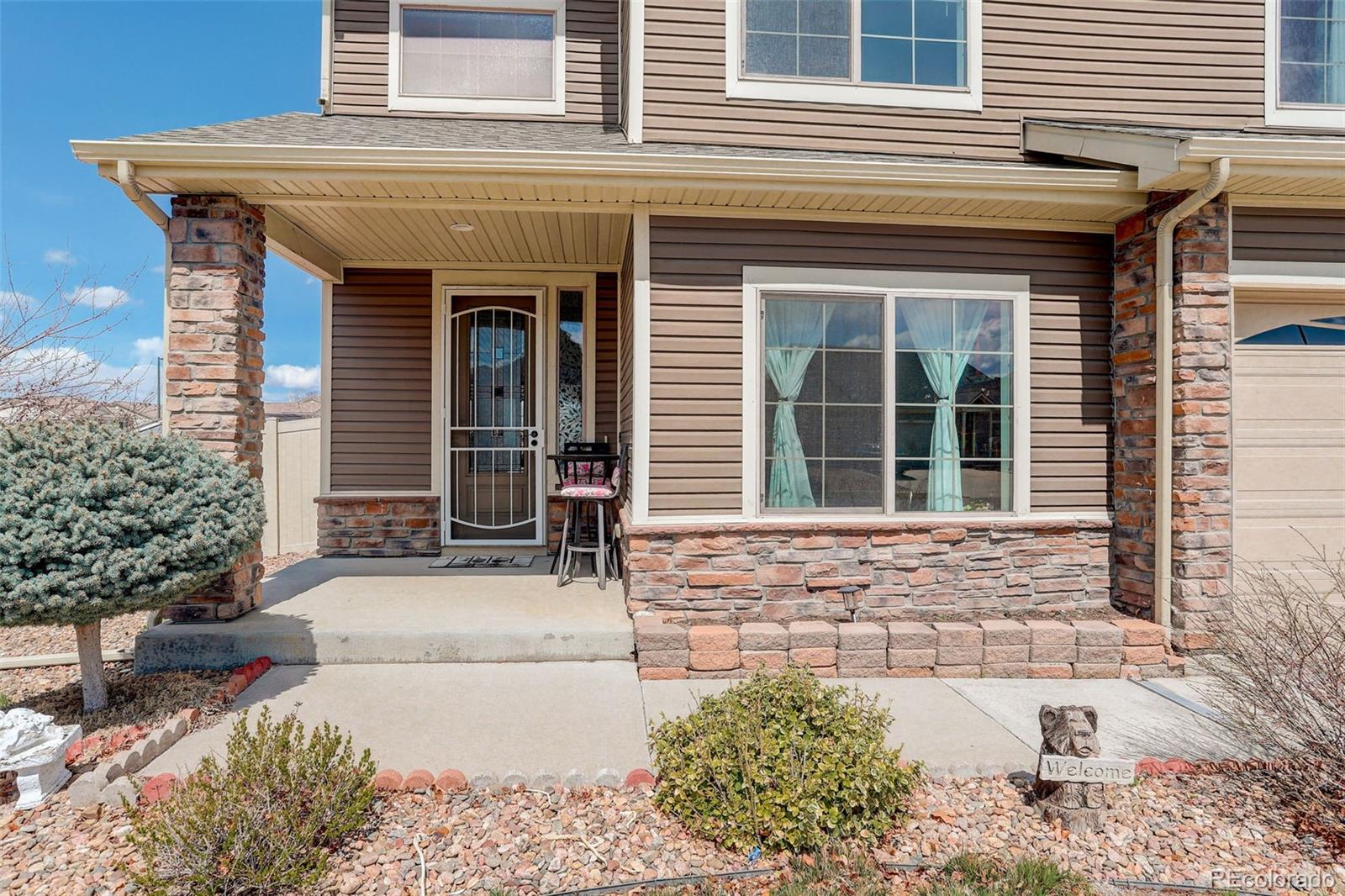4971 Ceylon Way Denver, CO 80249 - Photo 4 of 40 a front view of a house with a porch