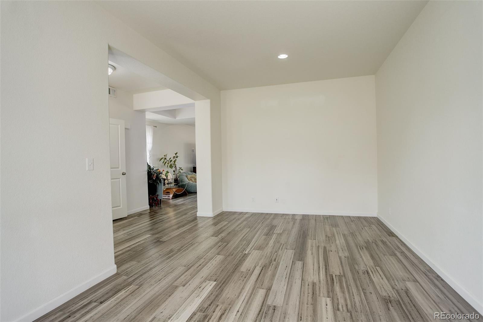 4971 Ceylon Way Denver, CO 80249 - Photo 6 of 40 a view of a room with wooden floor staircase and a hallway