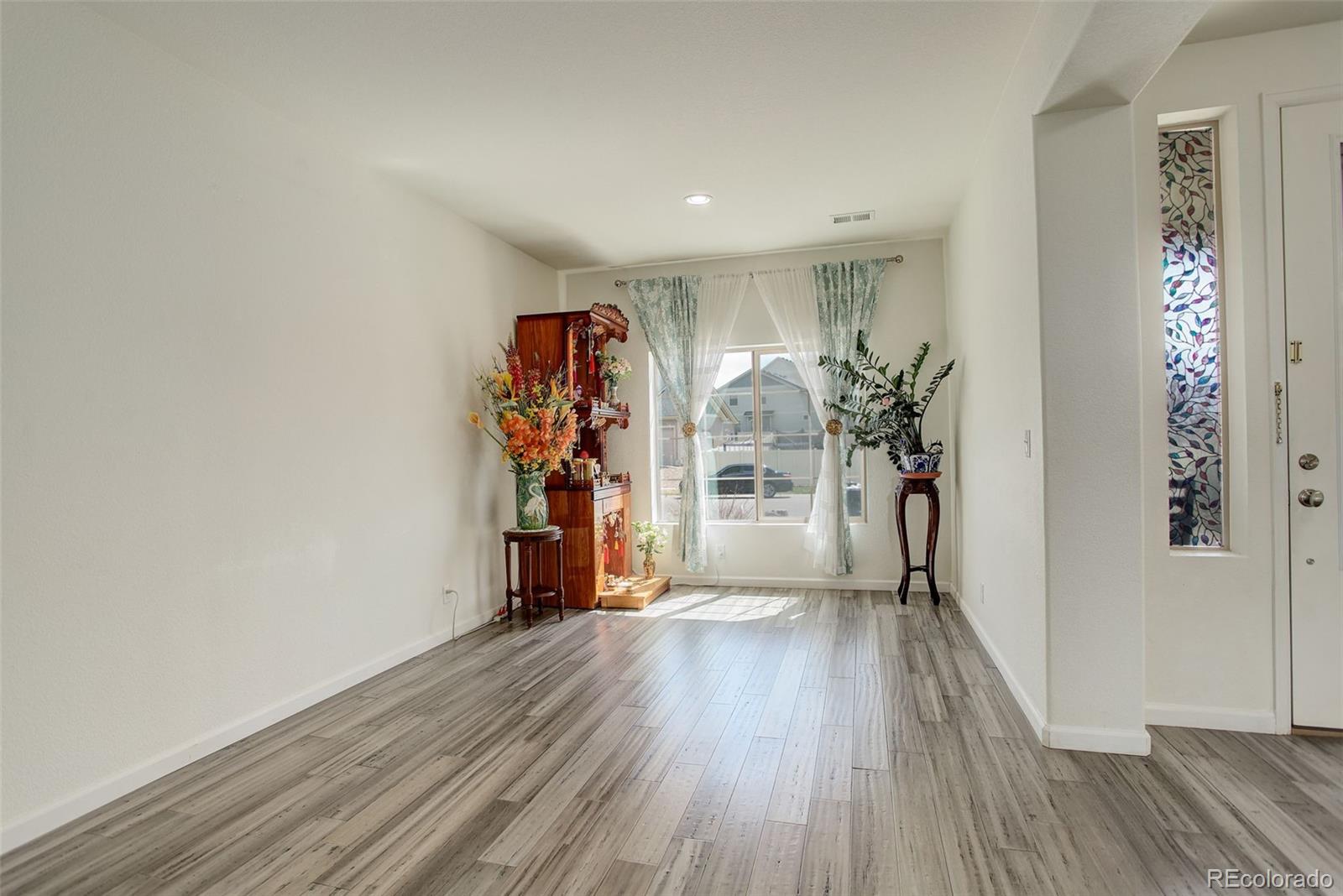 4971 Ceylon Way Denver, CO 80249 - Photo 7 of 40 a view of a room with wooden floor and closet