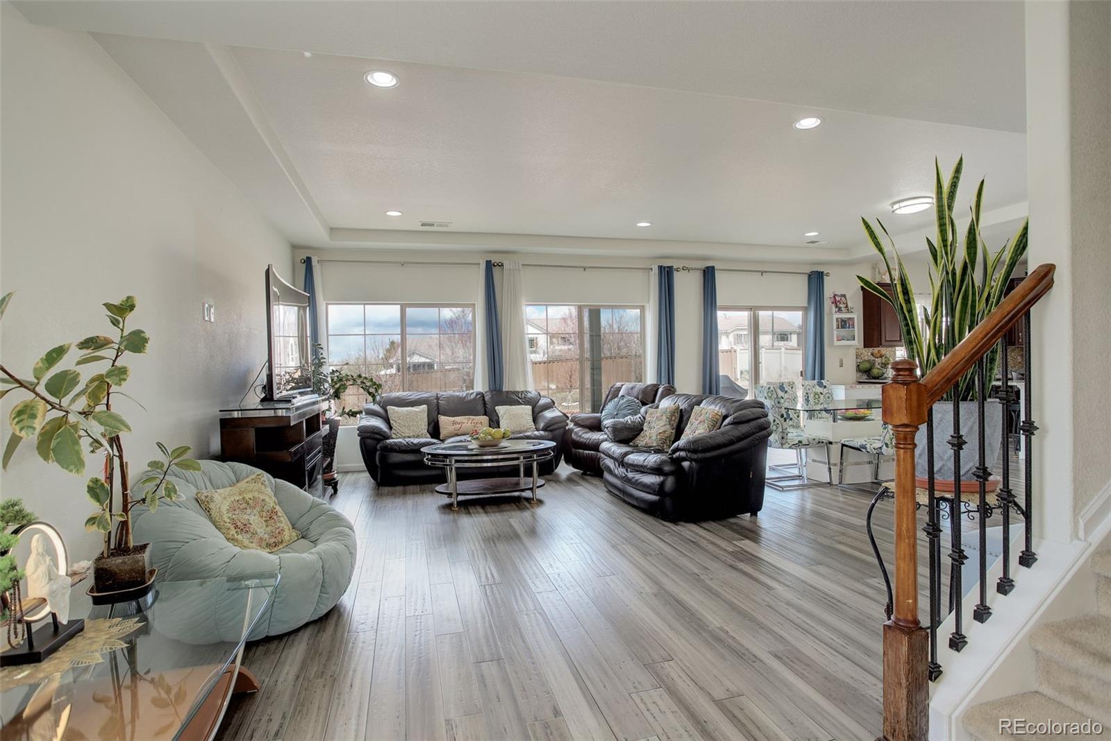 4971 Ceylon Way Denver, CO 80249 - Photo 8 of 40 a living room with furniture and wooden floor