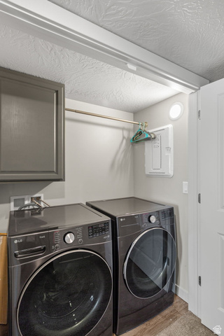 6231 Winding Way, Unit K105 Hurricane, UT 84737 - Photo 16 of 20 Laundry area with electric panel, separate washer and dryer, wood finished floors, and a textured ceiling