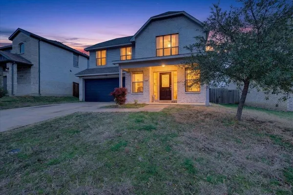a front view of a house with a yard