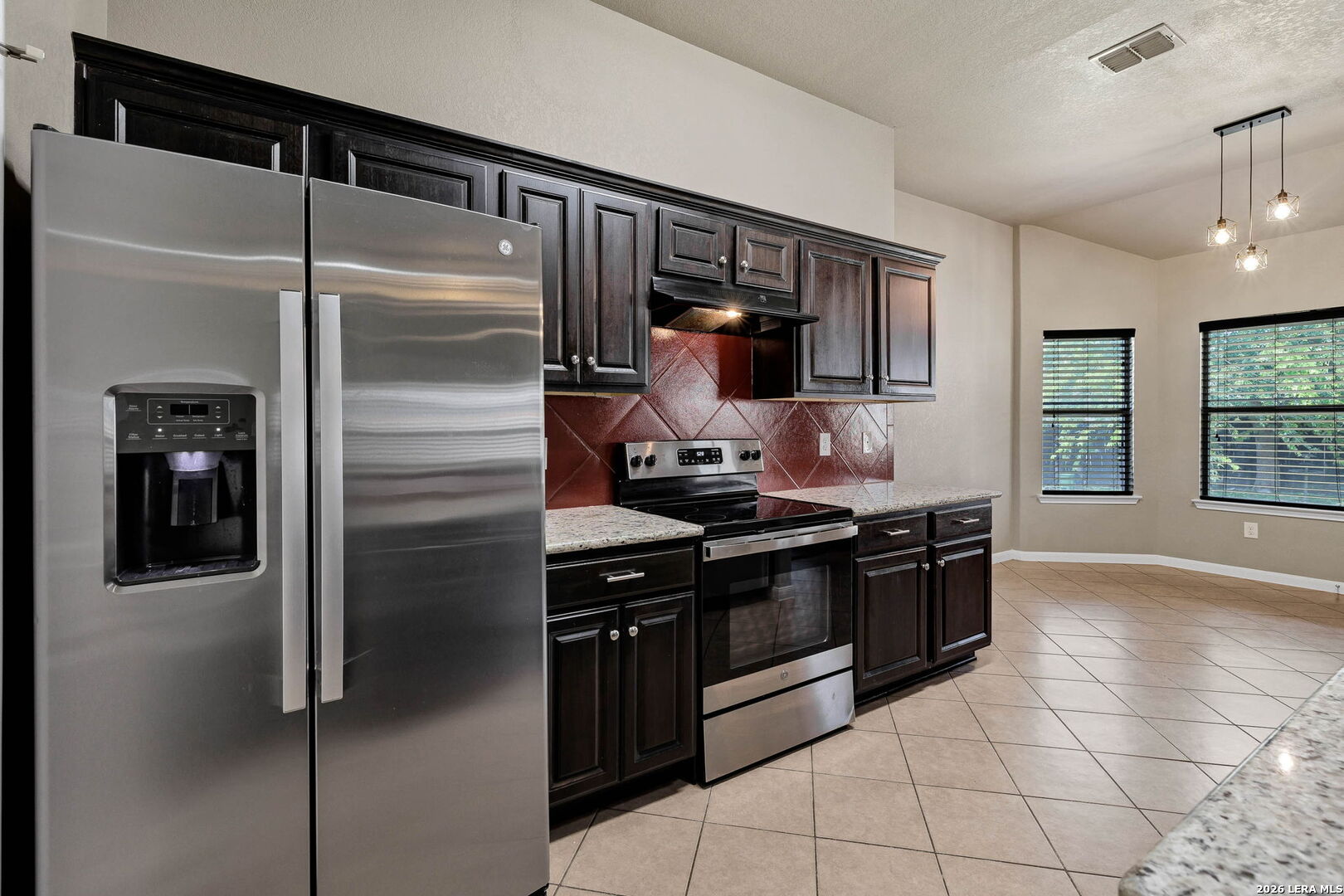 4015 Shervin Way Converse, TX 78109 - Photo 17 of 43 a kitchen with stainless steel appliances granite countertop a refrigerator and a stove top oven