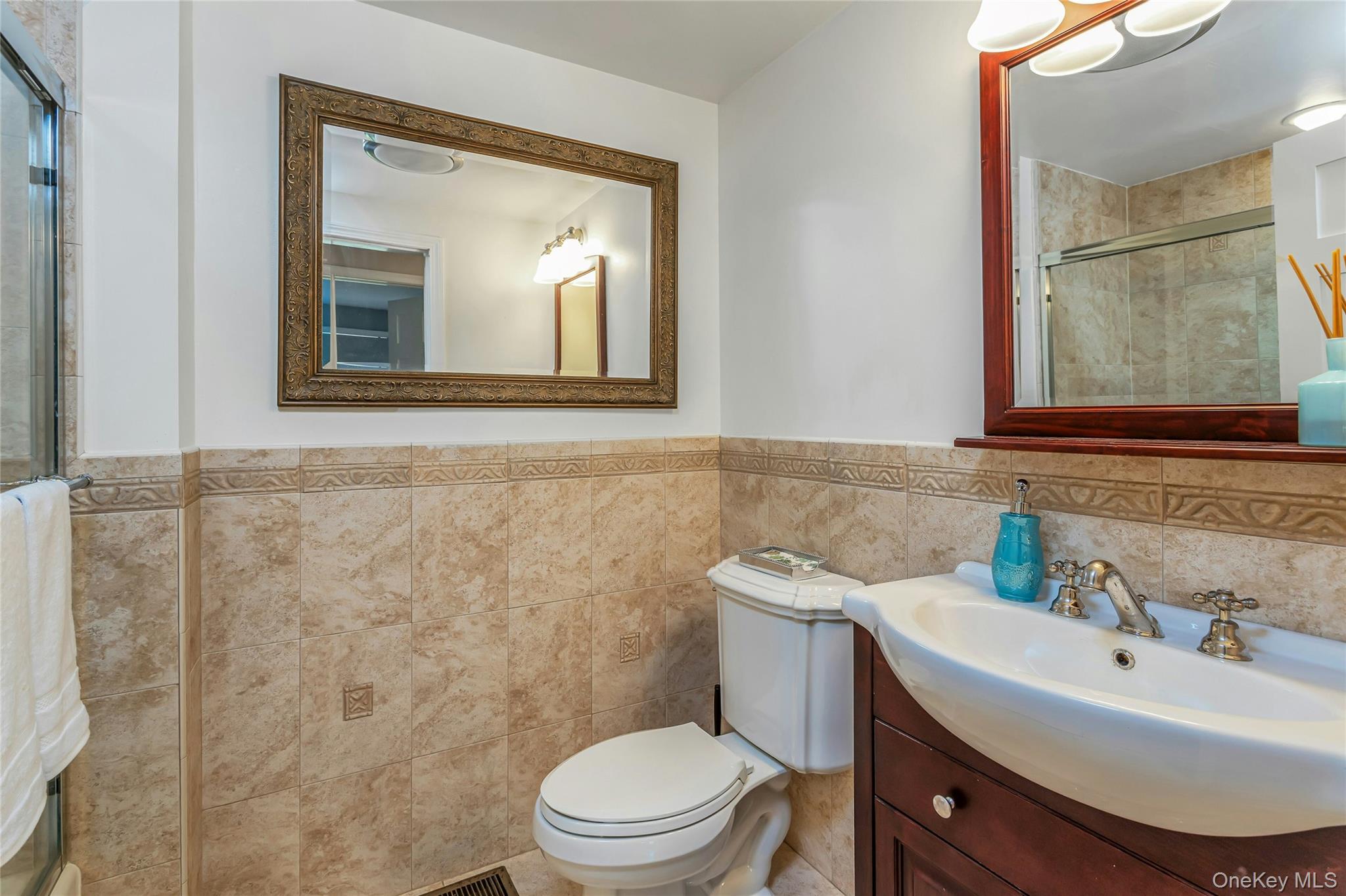 340 Osceola Road Jefferson Valley, NY 10535 - Photo 19 of 48 a bathroom with a sink a mirror and a toilet