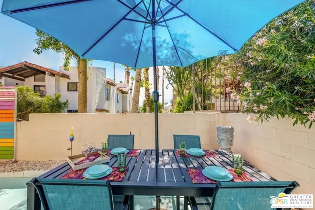 a yellow and red umbrella sitting in front of a building