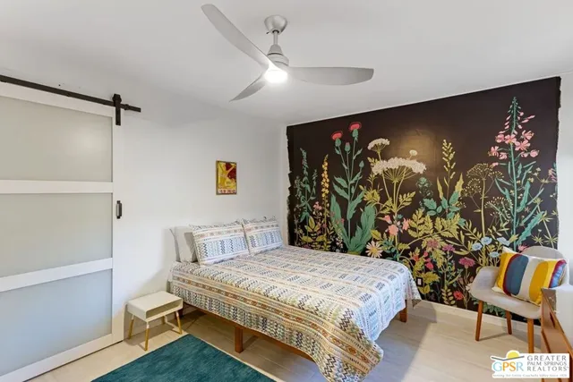 a bedroom with a bed and a glass door