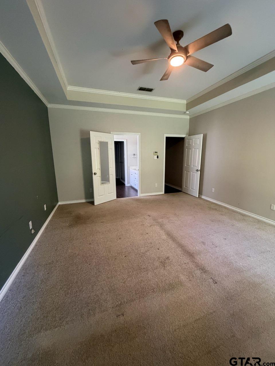 3204 Pebblebrook Circle Tyler, TX 75707 - Photo 12 of 18 a view of an empty room with a ceiling fan