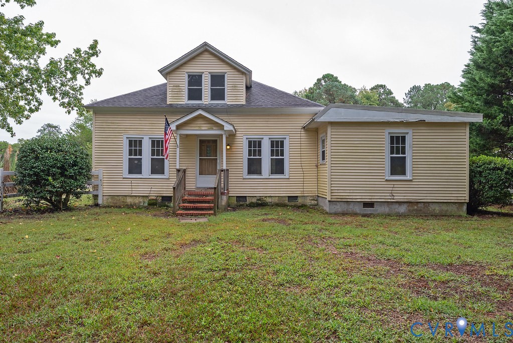 1881 Fairport Road Reedville, VA 22539 - Photo 6 of 54 Yellow siding exterior with multiple windows, a fr