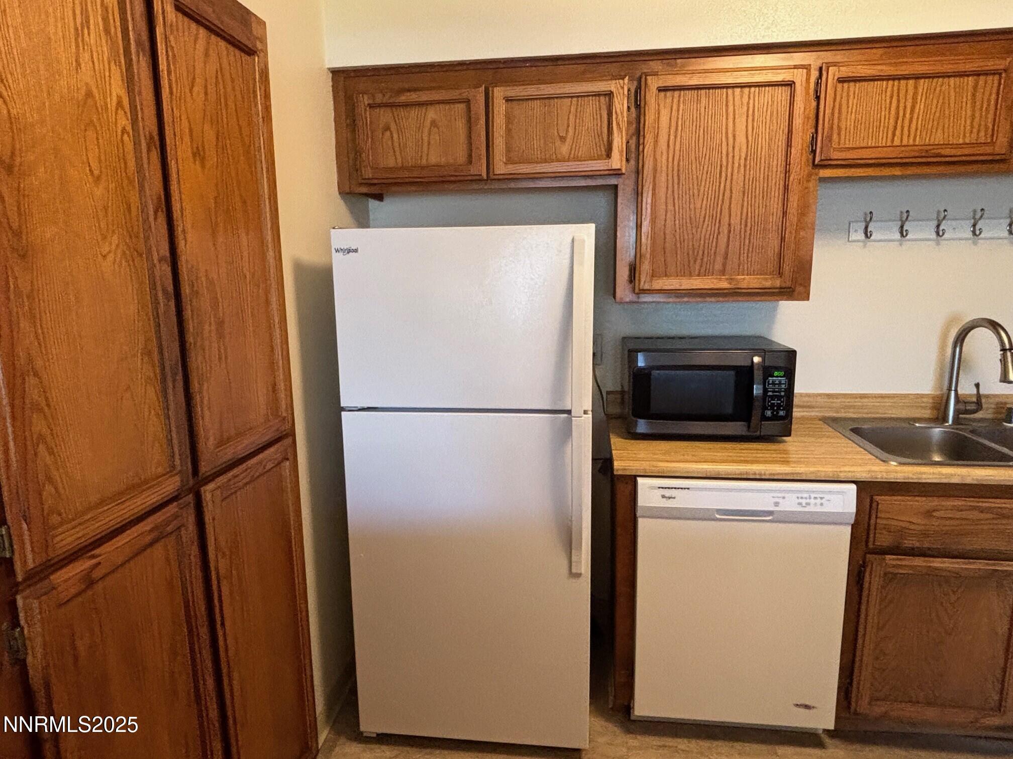 1465 East Peckham Lane, Unit 53 Reno, NV 89502 - Photo 6 of 19 a kitchen with stainless steel appliances a refrigerator and cabinets