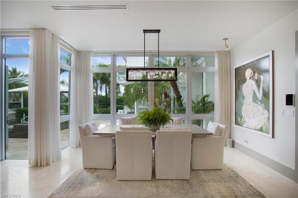 2290 Tarpon Road Naples, FL 34102 - Photo 27 of 50 Expansive dining area featuring a linear chandelier over a rectangular table