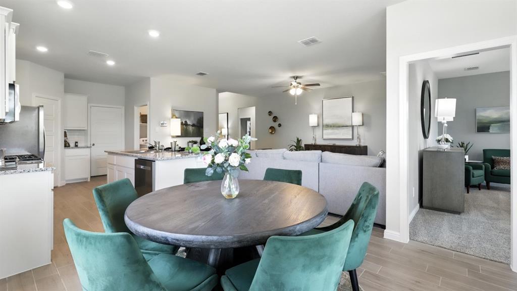 113 Tyler Street Grandview, TX 76050 - Photo 9 of 40 a view of a dining room with furniture and wooden floor