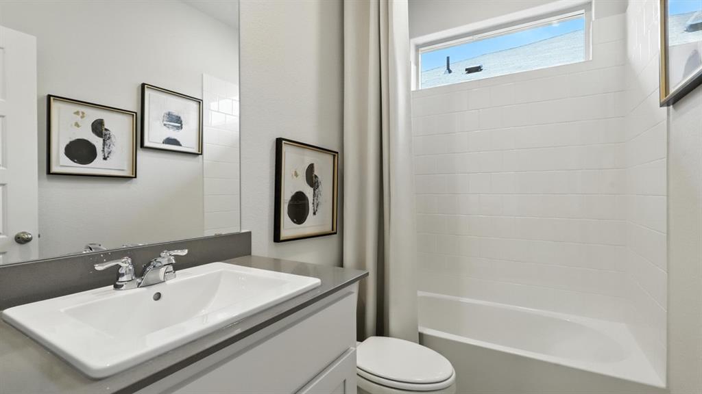 113 Tyler Street Grandview, TX 76050 - Photo 25 of 40 a bathroom with a sink a toilet and shower