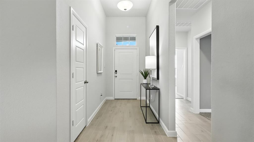 113 Tyler Street Grandview, TX 76050 - Photo 34 of 40 a view of a hallway with wooden floor and glass door