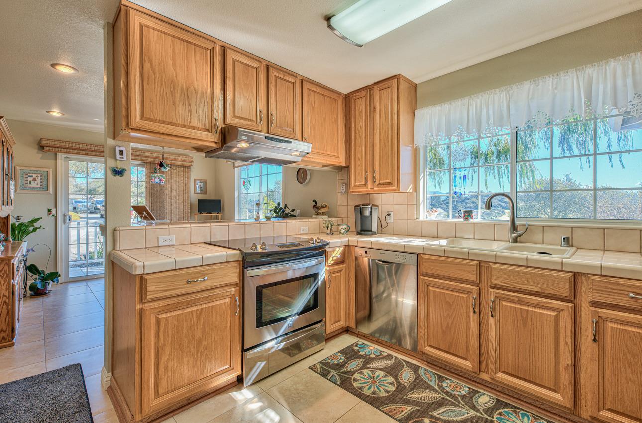 18401 Moro Road Salinas, CA 93907 - Photo 12 of 39 a kitchen with stainless steel appliances granite countertop a sink a stove and a wooden cabinets