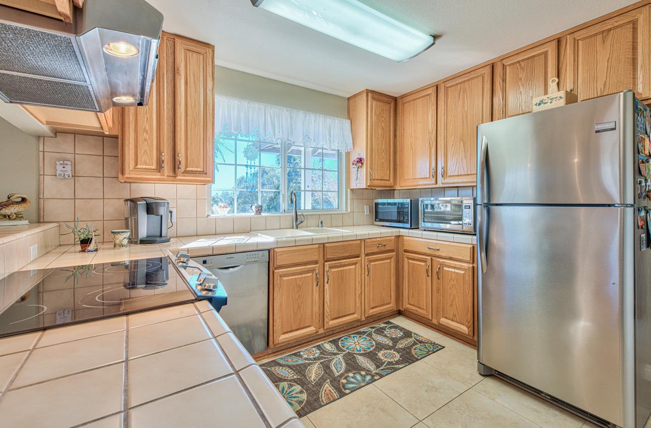 18401 Moro Road Salinas, CA 93907 - Photo 13 of 39 a kitchen with granite countertop a refrigerator and a sink