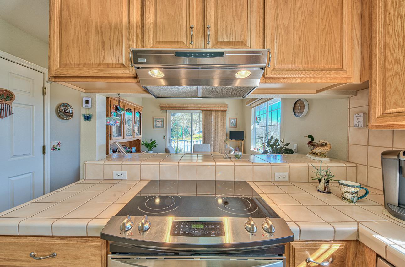 18401 Moro Road Salinas, CA 93907 - Photo 14 of 39 a kitchen with kitchen island a large window a sink and cabinets