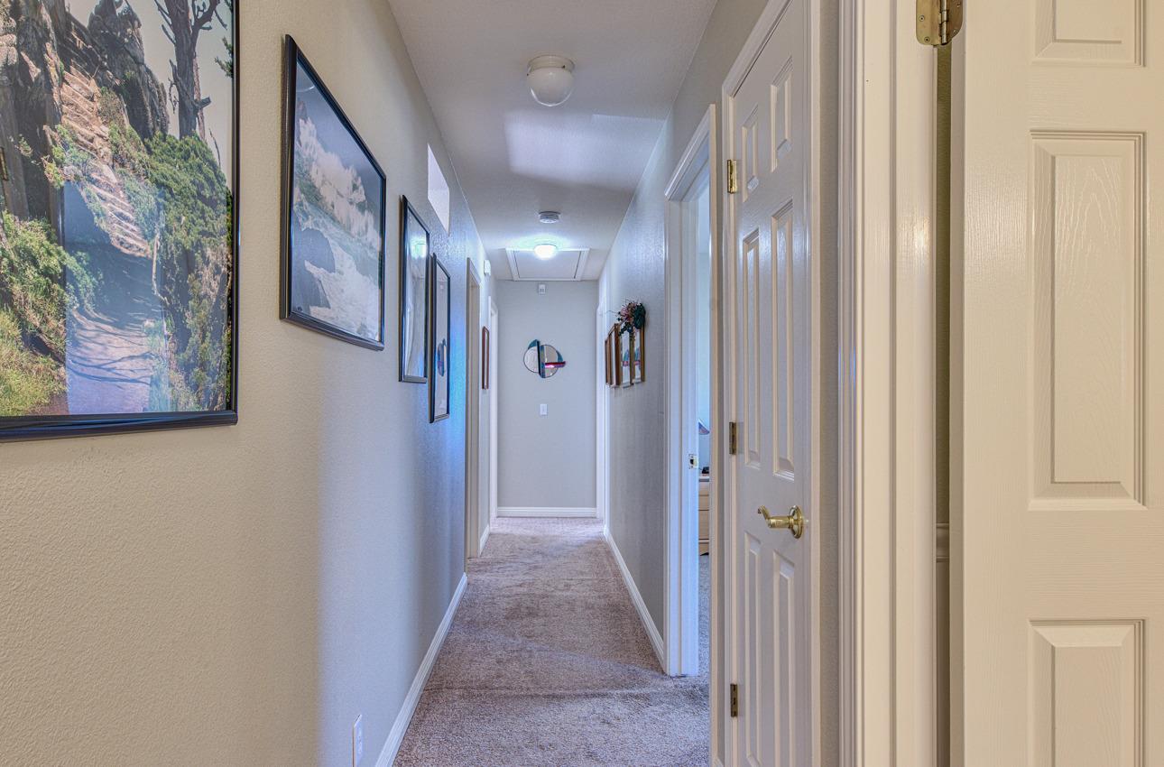 18401 Moro Road Salinas, CA 93907 - Photo 20 of 39 a view of a hallway with paintings on the wall