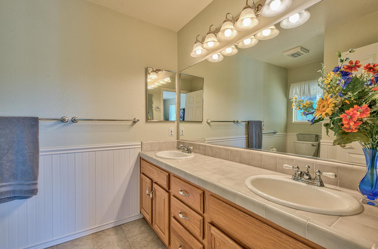 18401 Moro Road Salinas, CA 93907 - Photo 24 of 39 a bathroom with a double vanity sink and a mirror