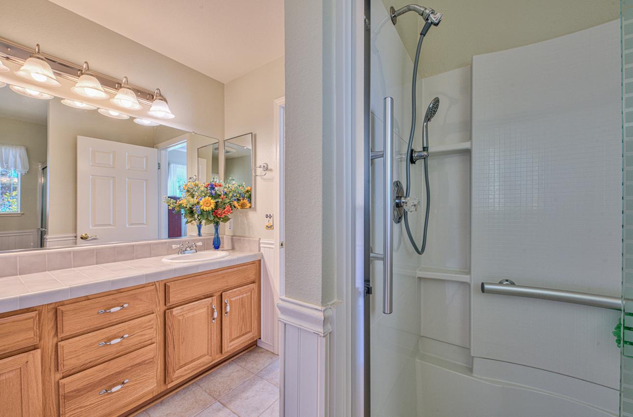 18401 Moro Road Salinas, CA 93907 - Photo 25 of 39 a bathroom with a shower sink and mirror